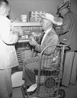 Governor Earl Long Sitting in Bread Basket at Supermarket