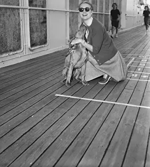Grace Kelly Plays with Pet Weimaraner