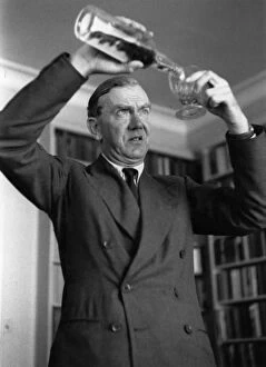 Images Dated 9th April 2016: Graham Greene Pours Drink