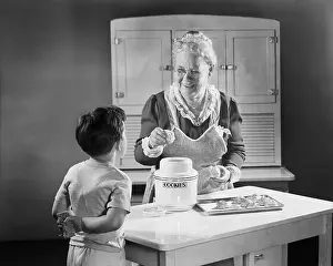Grandmother Prints: Grandmotherly Woman Making Cookies for a Boy