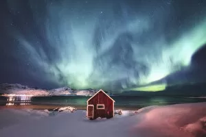 Calm Gallery: Green northern lights over red house Lofoten islands, Norway Aurora