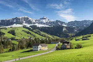 Green pastures in Appenzellerland in front of the snow-capped Appenzell Alps, Canton of Appenzell-Innerrhoden, Switzerland, Europe