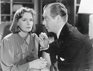 Prints of (Original Caption). Actress Greta Garbo sits listening to her co-star in the 1939 Metro-Goldwyn-Mayer production of Ninotchka'. Undated movie still Timeless Elegance: The Iconic Greta Garbo Collection: Greta Garbo In Movie Ninotchka
