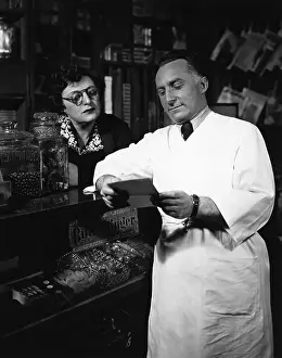 Counter Prints: Grocer Reads Customer'S List @Counter