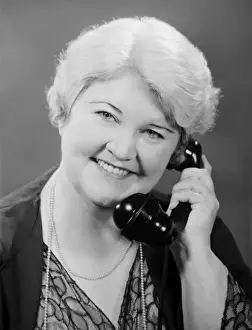 50 59 Years Prints: Well groomed mature woman talking on phone, (B&W), close-up, portrait