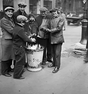 Group Huddled Around a Fire