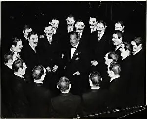 Benda Prints: Grover Whalen in Circle of Masked Men