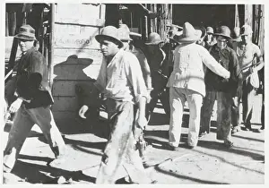 Exhausted Prints: Guard Frisking Workers