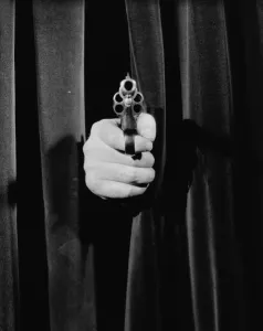 Strange Prints: Gun poking out from behind curtain