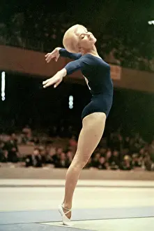 Prints of (Original Caption). Muriel Grossfeld of the U.S. shows form in the Women's Gymnastic event for individual standing Flips of History: Gymnast Muriel Grossfeld Performing at Olympics