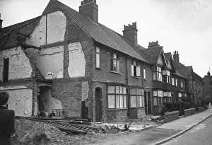 Prints of 1942: Half a house destroyed by a bomb on a residential street in Coventry. Original Publication: Picture Post - 1168 - Coventry - unpub Discover the Vision of Haywood Magee – A Master of Mid-Century British Life: Half A House