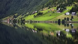 Hamlet of Heggland reflected in Lake Oppheimsvatnet, Oppheim, Hordaland, Norway