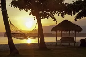 Hammock on a beach, at sunrise, near Pemenang, Lombok, Indonesia