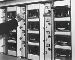 Buying Prints: Hand Placing Coin Into Automat Lunch