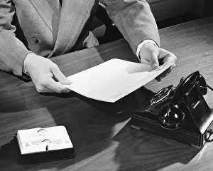 Using Phone Prints: Hand shot of man holding document