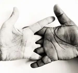 Two hands, of different skin colors, symbolizing brotherhood