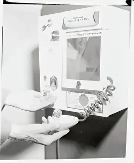 Hands Gripping Part of Shaving Machinery