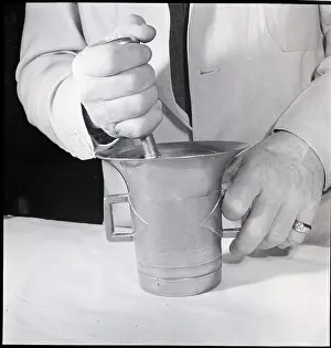 Grinding Prints: Hands of Pharmacist Using Mortar and Pestal