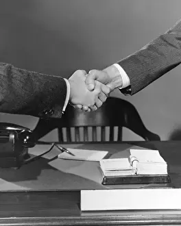 Sleeve Prints: Handshake over desk