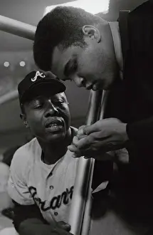 Hank Aaron Watching Muhammed Ali Sign Autograph