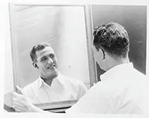 Harold Grange Looks in Mirror After Applying Makeup