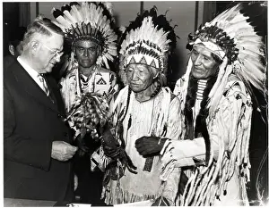 Harold Ickes Inspects Indian Weapon
