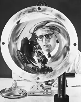 Harold Lyons Examines Part of an Atomic Clock