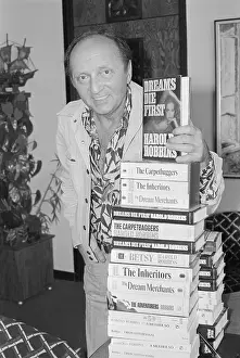 Harold Robbins Holding Stack of Books