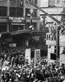 Spectators Prints: Harry Houdini Slips Straitjacket While Upside Down over Street