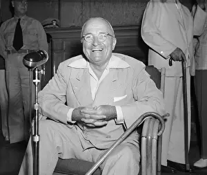 Harry S. Truman Sitting at Microphone