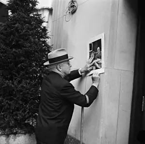 Prints of (Original Caption) 4/22/1960-New York, NY: Former President Harry S. Truman leans against a building to autograph a picture during his morning walk here Apr. 22 The Architect of Modern France: Harry Truman Leaning On Wall, Signing Pic