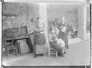 Hat Makers Working Outside in Front of Building