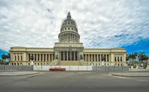 Colonnade Prints: Havanas Capitol building with red vintage car and dramatic sky, Cuba
