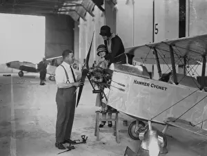 Prints of Two women looking at the engine of a Hawker Cygnet at Lympne in Kent. (Photo by E Bacon/Getty Images) Topical Press Agency Prints: Hawker Cygnet