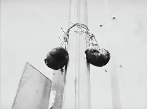 Two Heads Hanging on Post