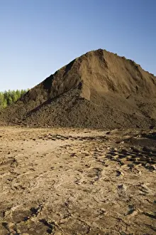 Trace Prints: Heavy tire tracks and a mound of topsoil in a commercial sandpit, Quebec, Canada