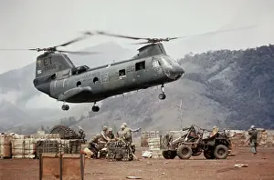 Helicopter in Flight near Mountain Range
