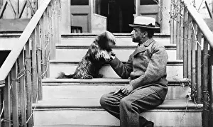 Porch Prints: Henry Adams Playing with Dog on Porch Steps