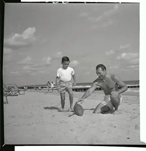 Herschel Martin Holding Football for Young Boy