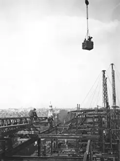 Prints of 1928: A press photographer at work in a brick crate, 270 feet above the street, photographing the construction of a new building over Baker Street Station, London Daredevil Construction Worker Prints: High Photographer