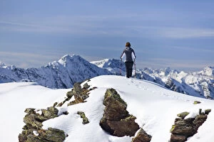 Hiker in the snow on the top of Roethenspitz Mountain above Penser Joch Pass, Sarn Valley, Alto Adige, Italy, Europe
