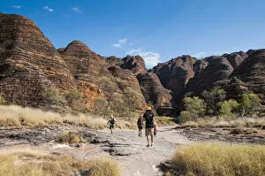 Hikers in front of the Bungle Bungles, beehive-shaped sandstone towers, Purnululu National Park
