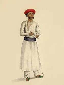 Hindu man stands in white tunic over white trousers