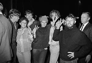 Hippies in Handcuffs Give Peace Signs