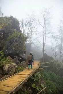 Images Dated 31st January 2017: Hmong minority steps on wood staircase in Sa Pa