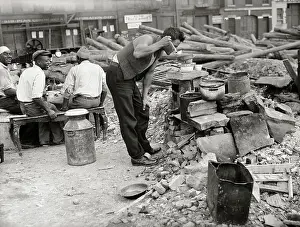 Hobo in Makeshift Camp and Tasting from a Pot of Food
