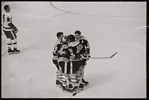 Hockey Players Embracing on Ice
