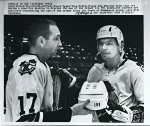 Hockey Teammates Examining Helmet