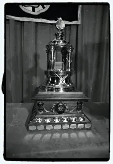 Prints of Photo shows the Vezina Hockey Trophy Frozen Moments: A Journey Through Hockey History: Hockey Trophy Standing on Table