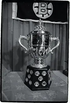 Prints of Photo shows the Clarence Campbell Hockey Trophy Frozen Moments: A Journey Through Hockey History: Hockey Trophy Standing on Table